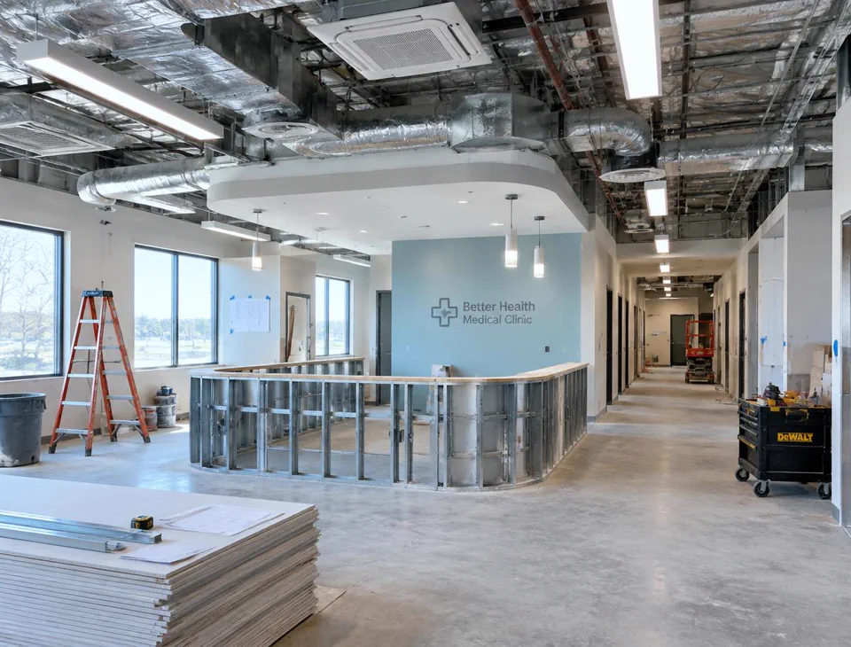 Medical clinic interior renovation in progress with exposed ceiling and new HVAC ductwork